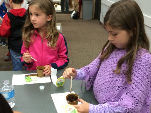 2 young girls planting seeds at Coquitlam Library's Plant a Seed READ! event.