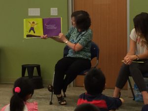 Coquitlam Library assistant reading the book at the Plant a Seed READ! event.